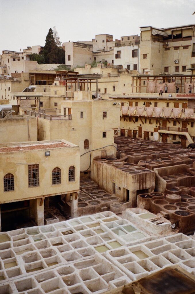 Discover the historic tanneries of Fes, Morocco, with an aerial view showcasing traditional dyeing vats.