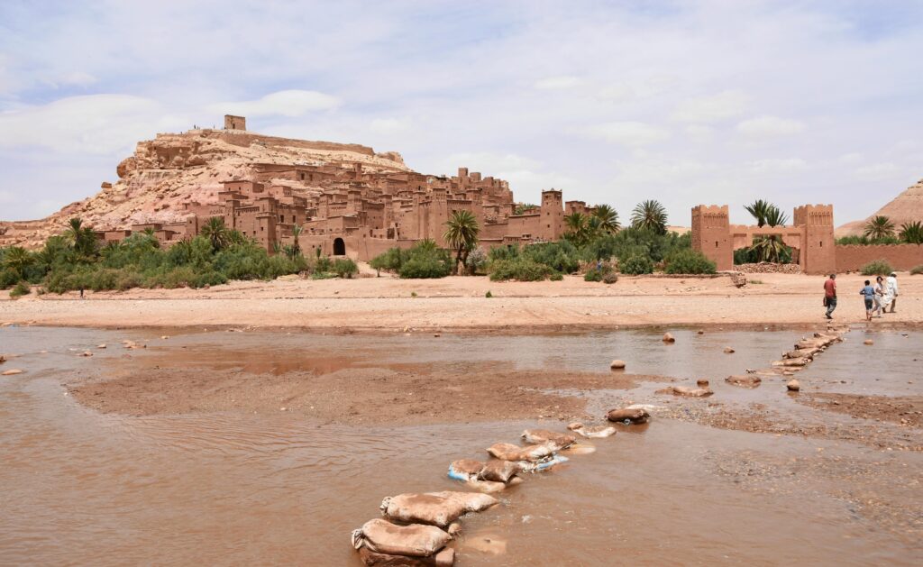 View of Aït Benhaddou, a historic ksar in Morocco, with desert surroundings.
